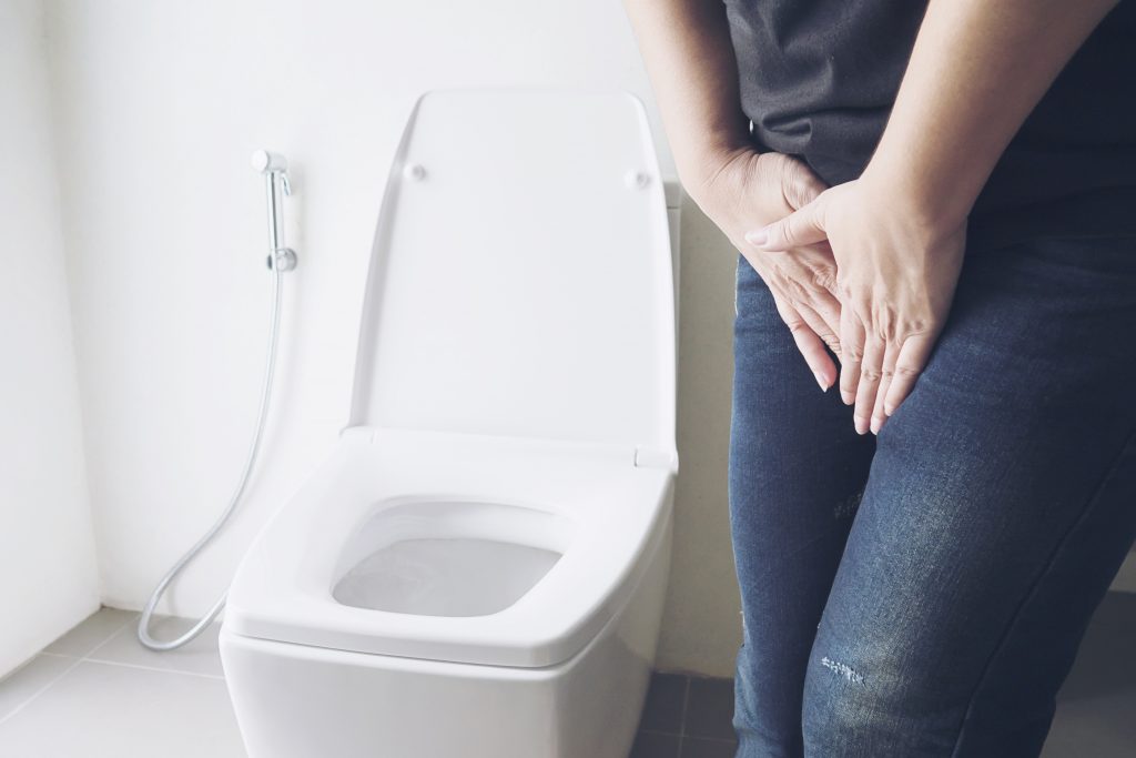 woman-holding-hand-near-toilet-bowl-health-problem-concept