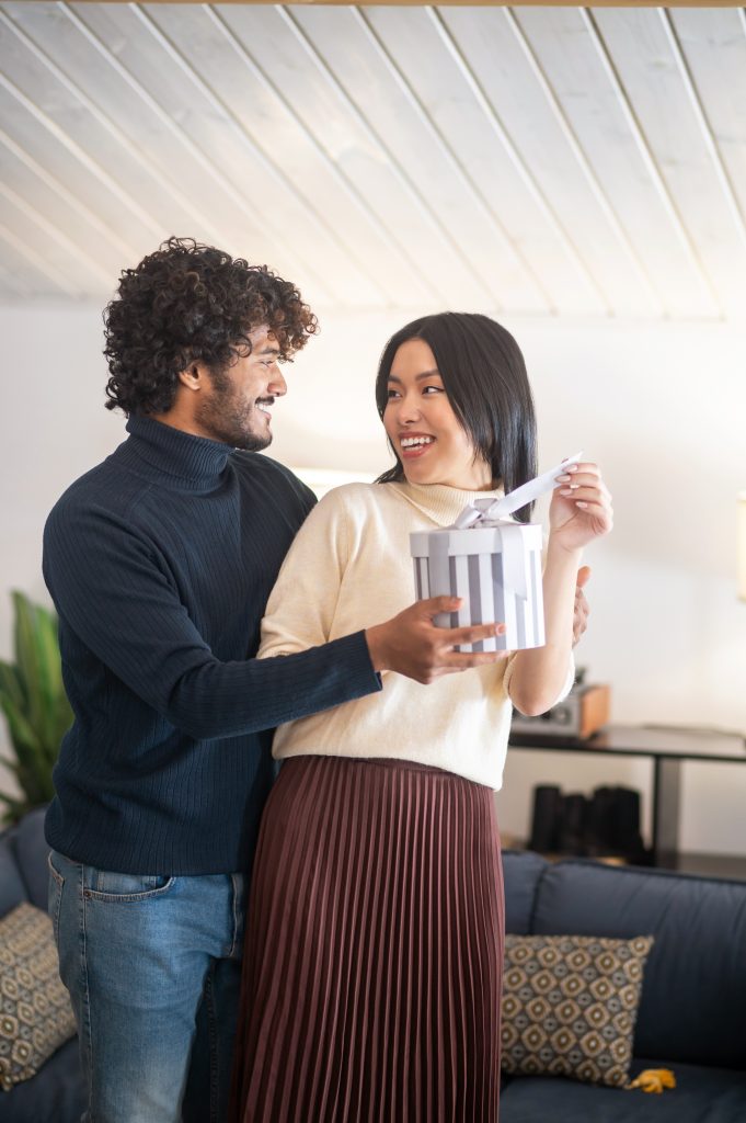 man-looking-giving-gift-joyful-woman