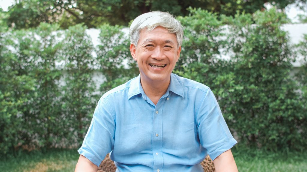 Portrait Asian Chinese senior man feeling happy smiling at home.