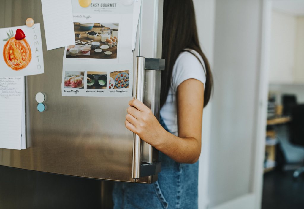 girl-picking-something-eat-out-fridge-min