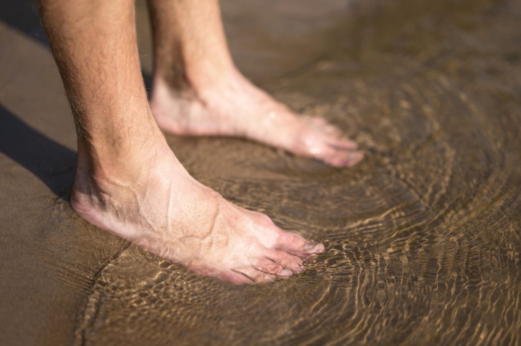 close-up-man-s-feet-water-min