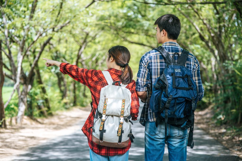 both-male-female-tourists-stand-see-map-road (1)-min